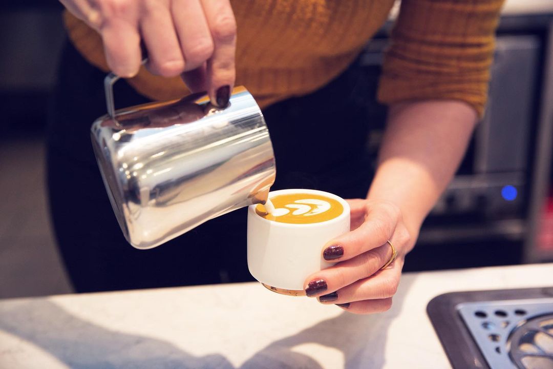 Barista pouring latte art