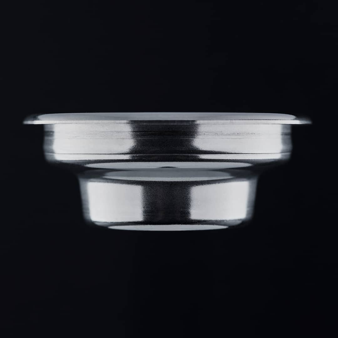 A floating metallic bowl-like object against a black background