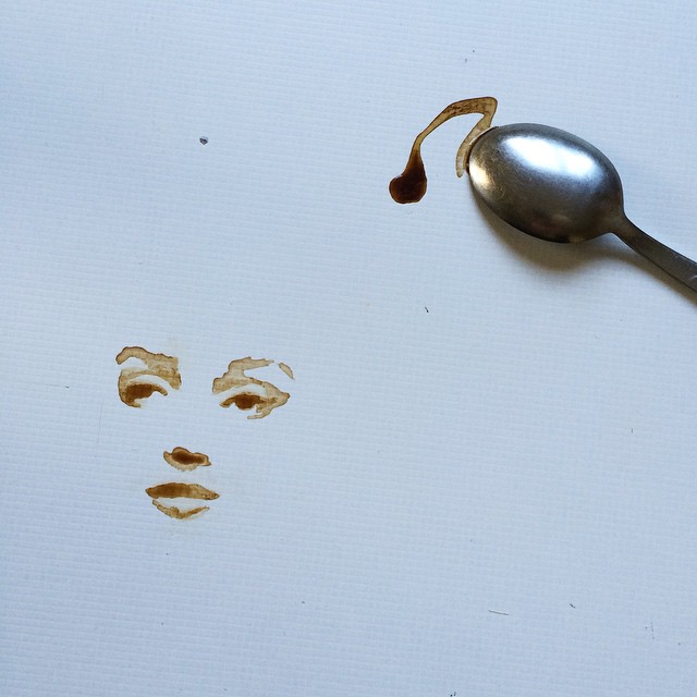 Creative representation of a face made with coffee spill and spoon