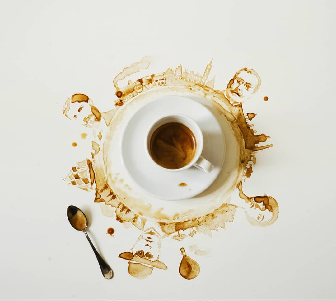 A whimsical coffee stain art surrounding a cup of espresso