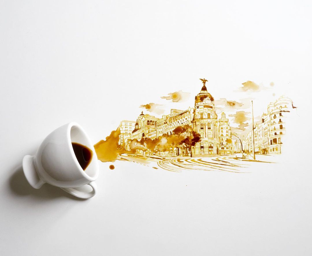 A spill from a coffee cup creatively transforming into an intricate cityscape drawing