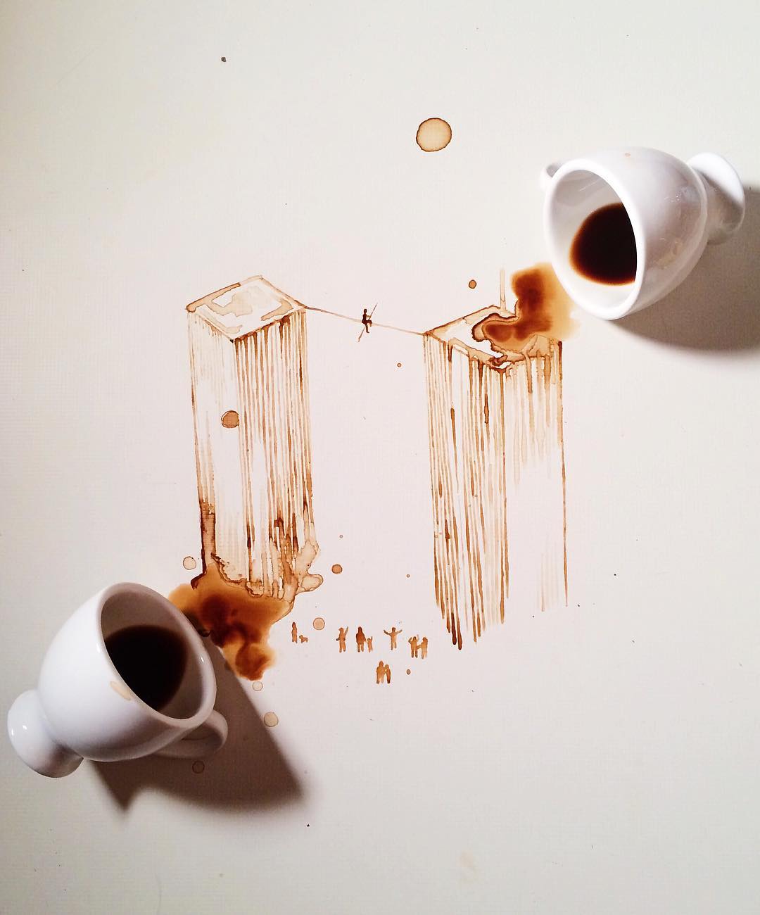 Clever use of spilled coffee to create an illusion of cityscape with people walking between twin towers