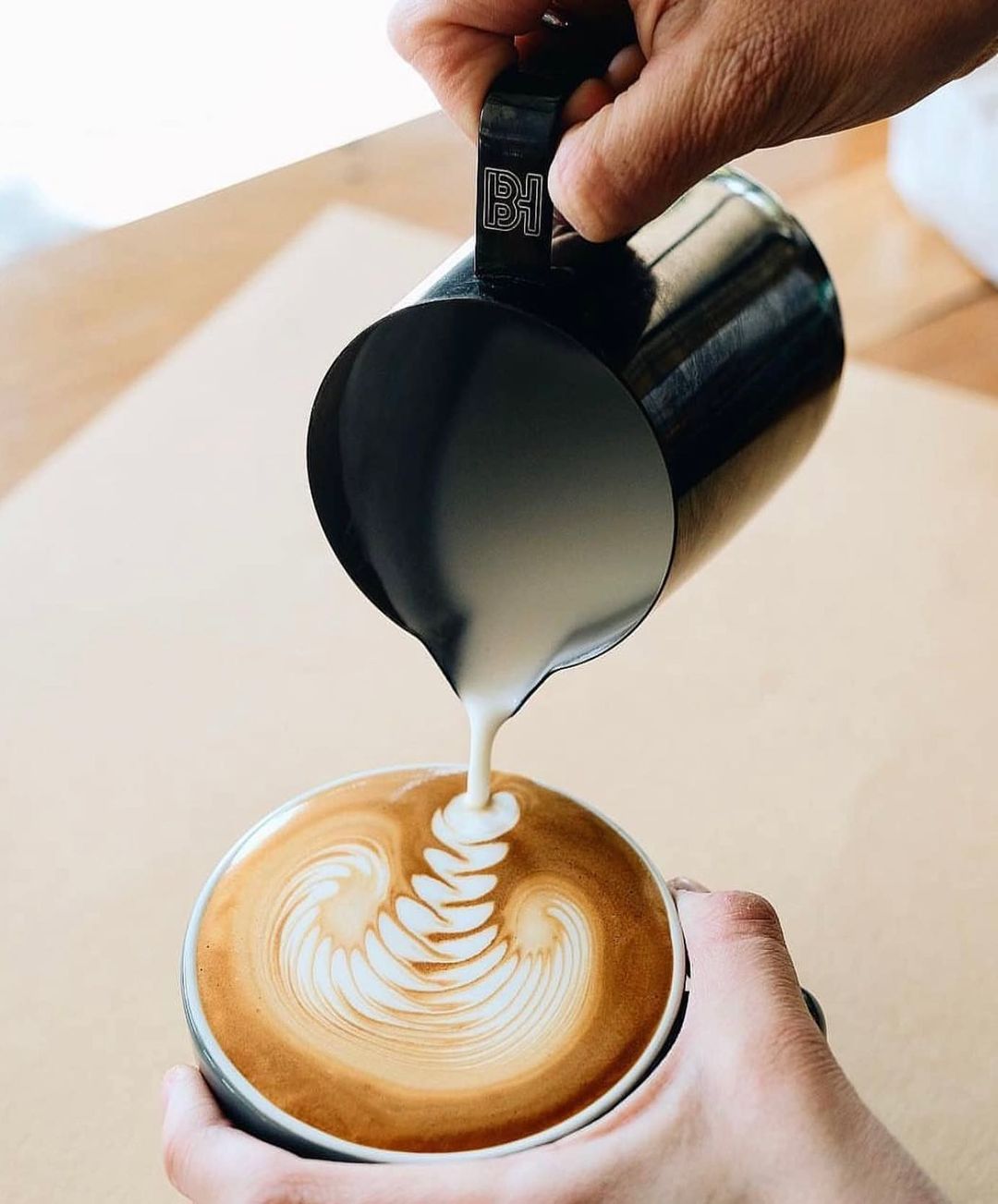 A skilled barista crafting a beautiful latte art