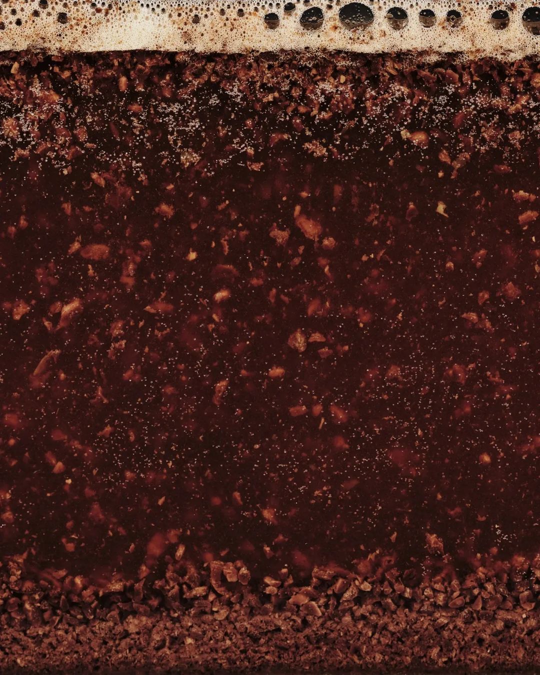 Close-up texture of a chocolate cake with frothy layer on top