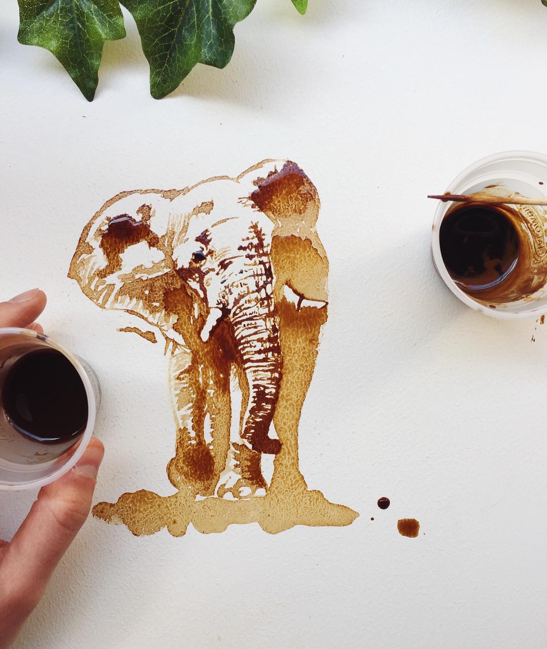 An inventive depiction of an elephant made with coffee spills and brush strokes