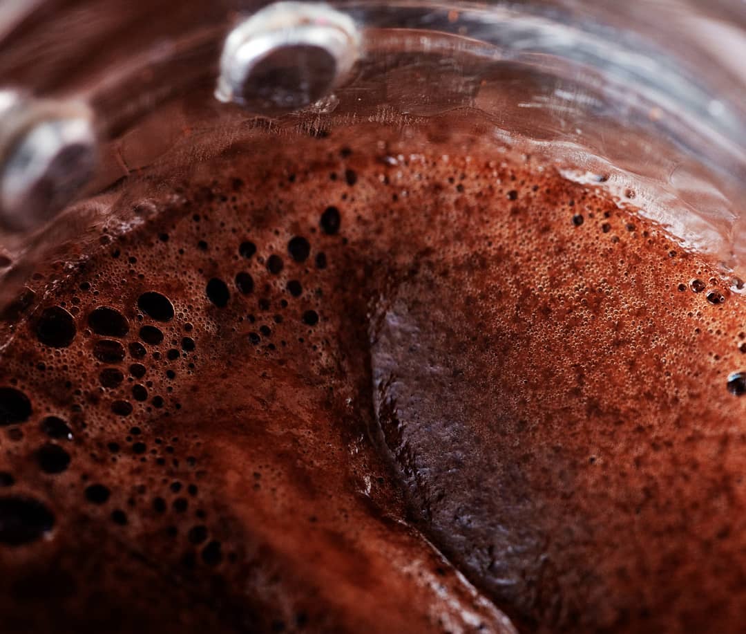 A close-up view of rich, bubbly espresso with a fine crema layer