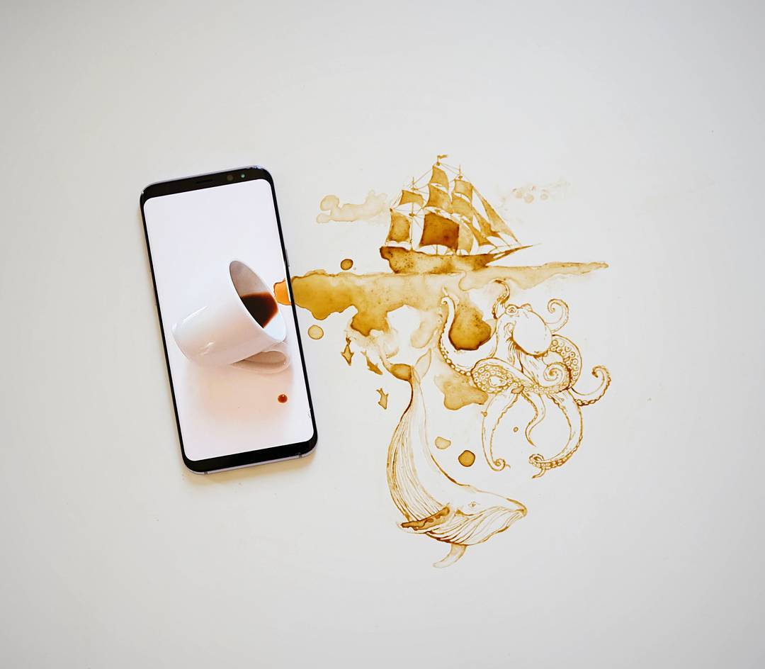 A cleverly creative coffee spill transformed into sea-themed art, featuring a ship and an octopus