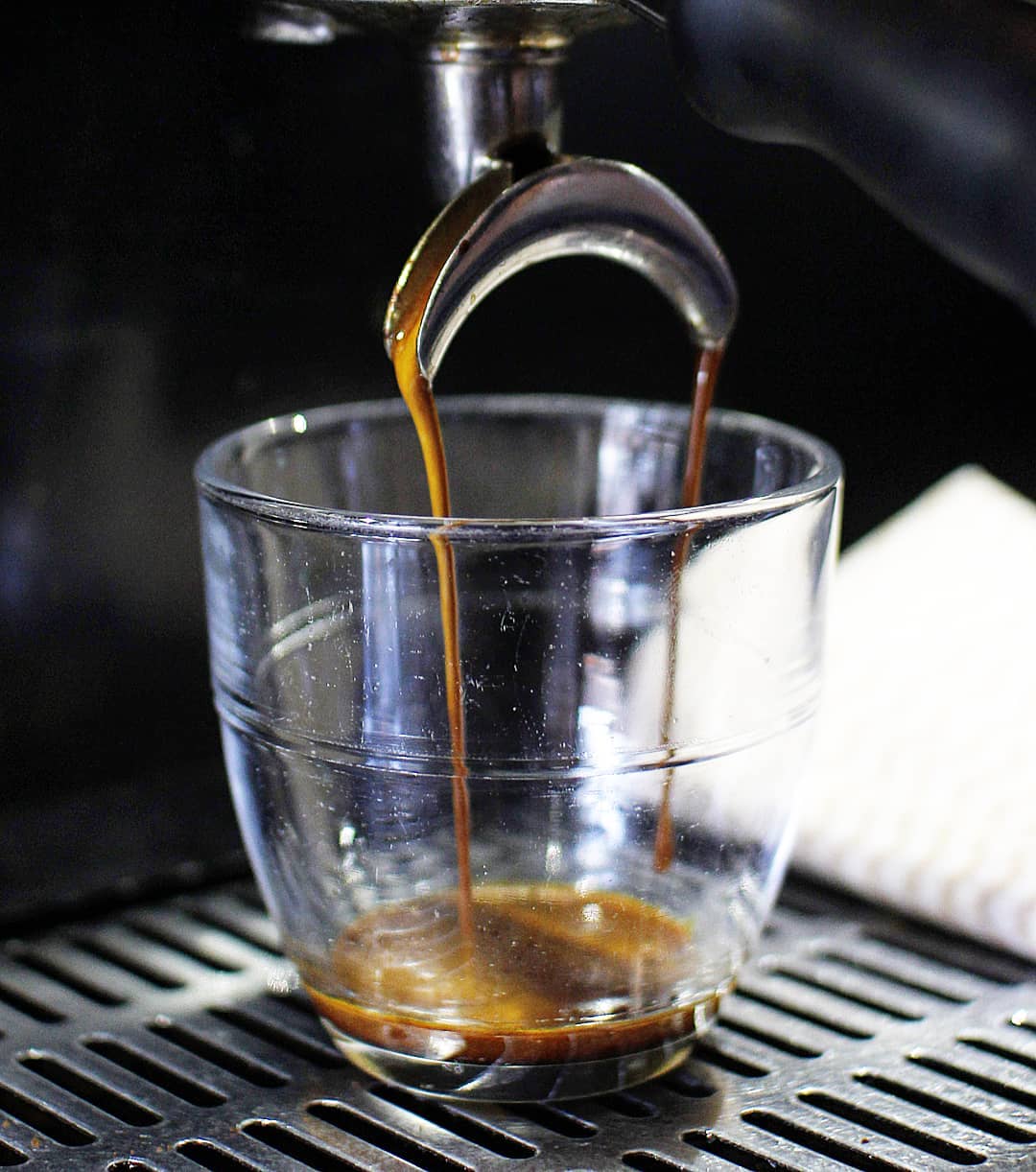 Freshly brewed espresso flowing into a glass