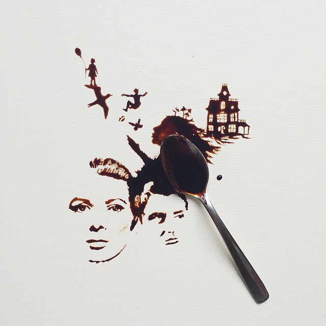 A cleverly crafted coffee art painting depicting faces and a haunted house