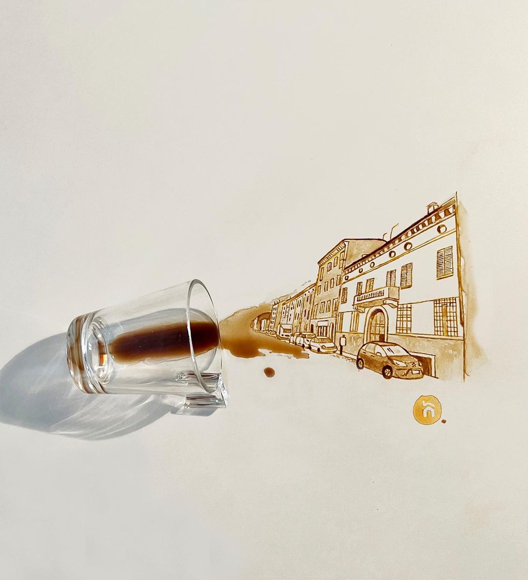 Spilled coffee artfully creating the illusion of a street scene on a canvas