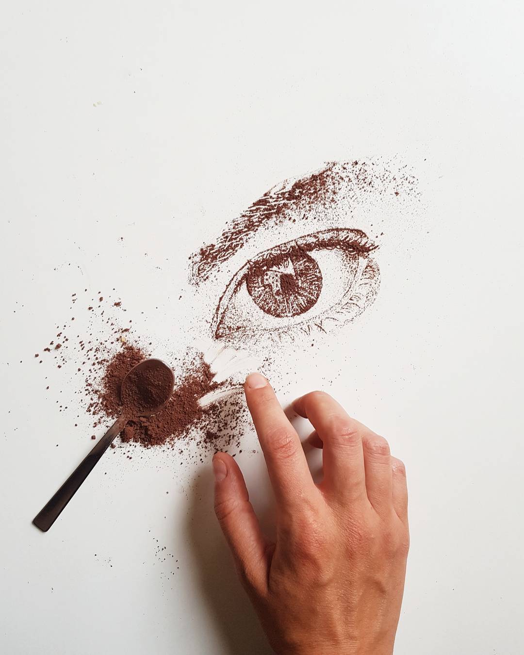 Intricate artwork of an eye created with coffee grounds