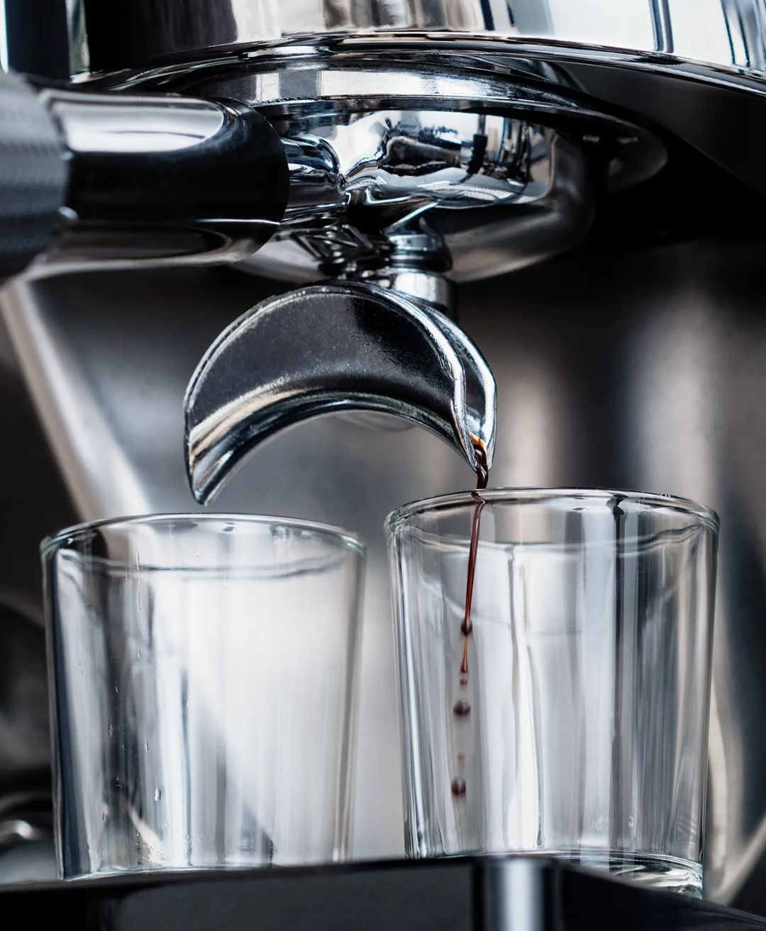 A closeup of an espresso machine pouring a fresh shot into a glass