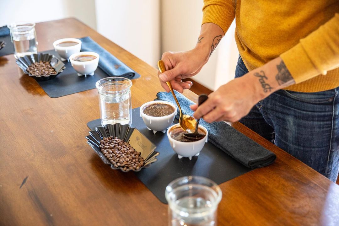 A person engaging in a coffee cupping session