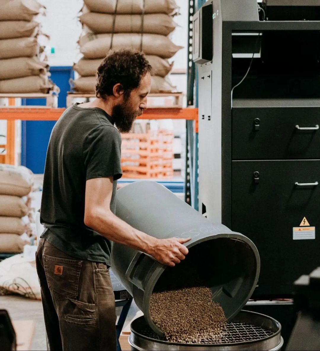 Person pouring coffee beans