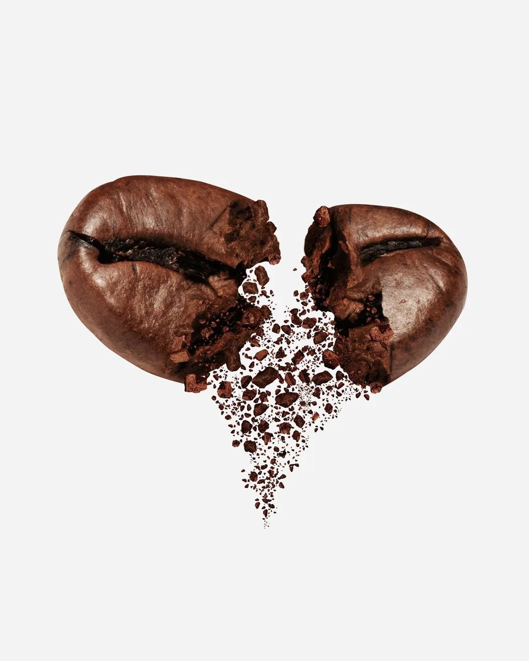 A coffee bean split in two forming a heart shape